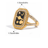 Gold ring with black stone and measurements on a white background