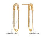 Gold safety pin earrings with clear stones on a white background
