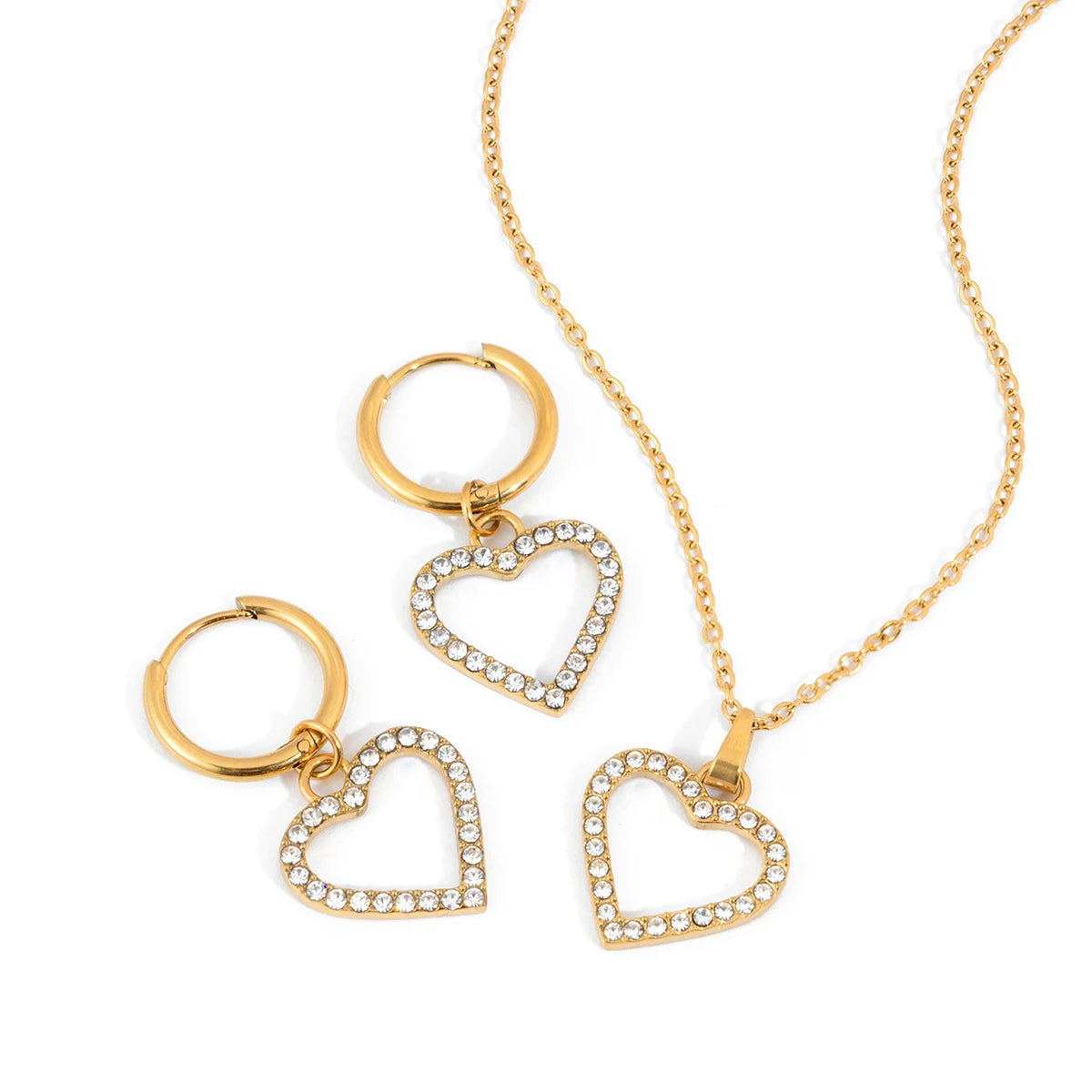Gold heart-shaped jewelry set including necklace and hoop earrings on a white background