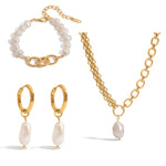 Gold jewelry set with pearl earrings, bracelet, and necklace on a white background