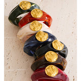 Wide resin bangle bracelet in bone color on wrist — tarnish-free stainless steel core