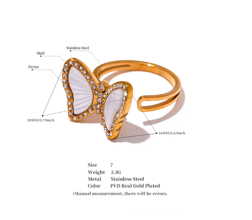 Gold butterfly ring with white center and measurement details on a white background