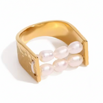Gold ring with pearls on a white background