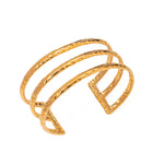 Gold bracelet with a textured design on a white background