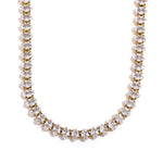 Necklace with alternating gold and clear beads on a white background