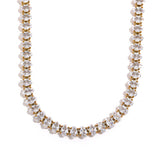 Necklace with alternating gold and clear beads on a white background