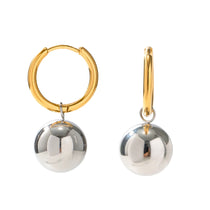 Gold hoop earrings with silver spherical pendants on a white background