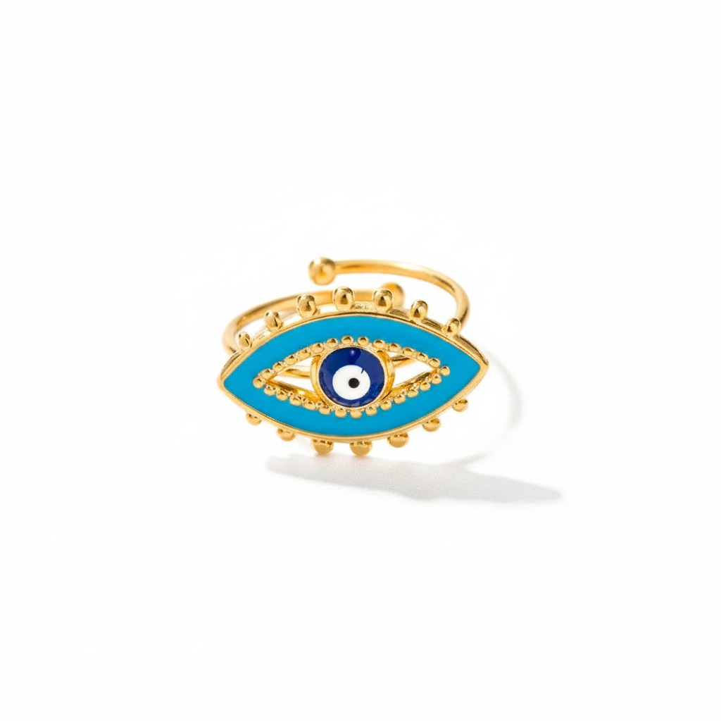 Gold ring with blue eye design on a white background