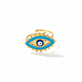 Gold ring with blue eye design on a white background