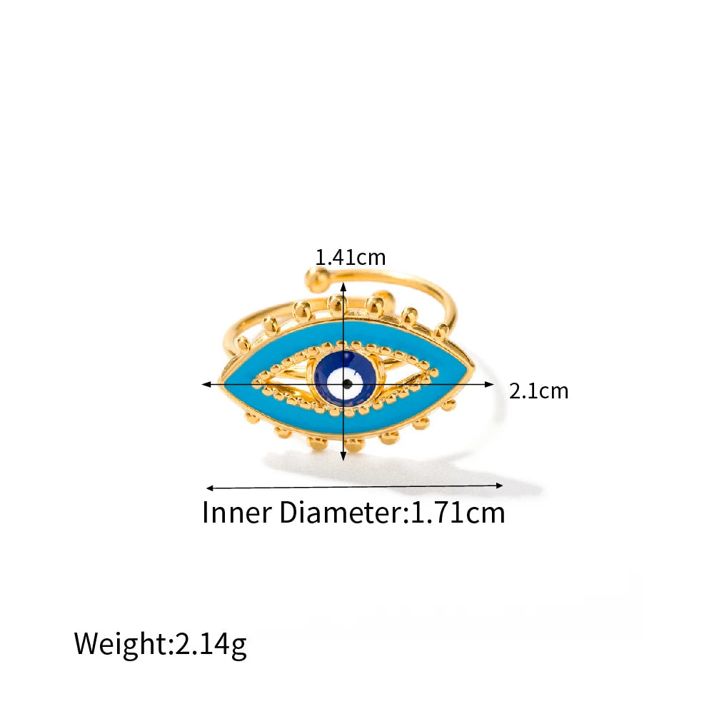 Gold and blue eye-shaped ring with measurements on a white background