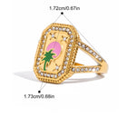 Gold ring with a palm tree design and measurements on a white background
