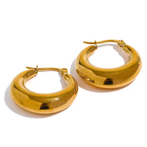 Gold hoop earrings on a white background