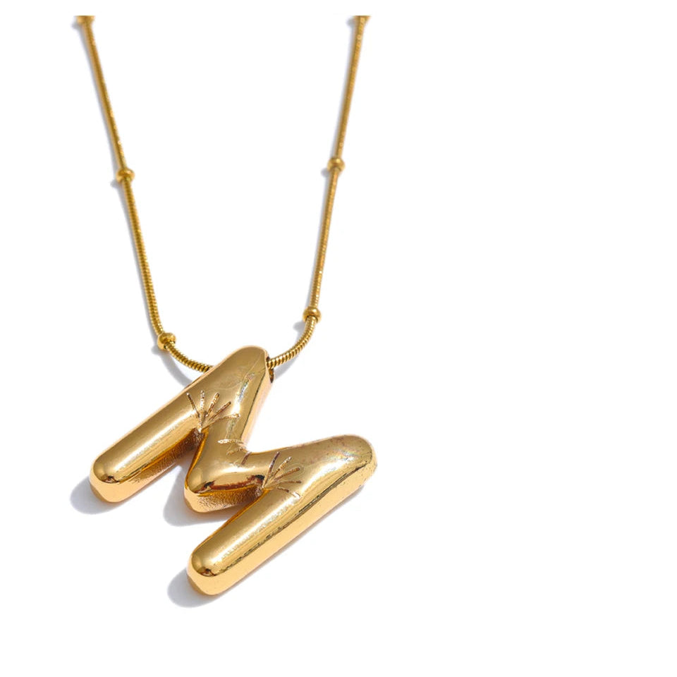 Gold necklace with a unique pendant on a white background