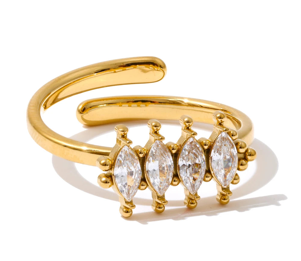 Gold ring with marquise-shaped gemstones on a white background