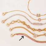 Gold and pink jewelry set on a light background
