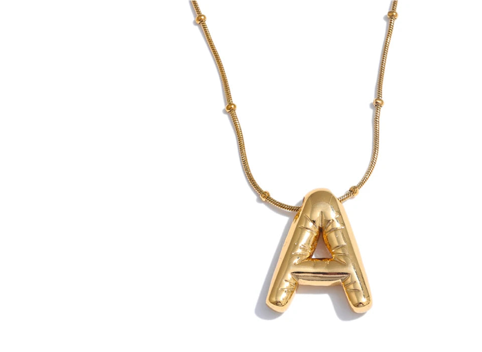 Gold necklace with a letter 'A' pendant on a white background