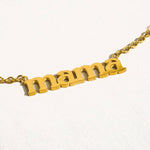 Gold necklace with 'mama' pendant on a white background