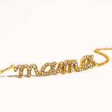 Gold 'mama' necklace with rhinestones on a white background