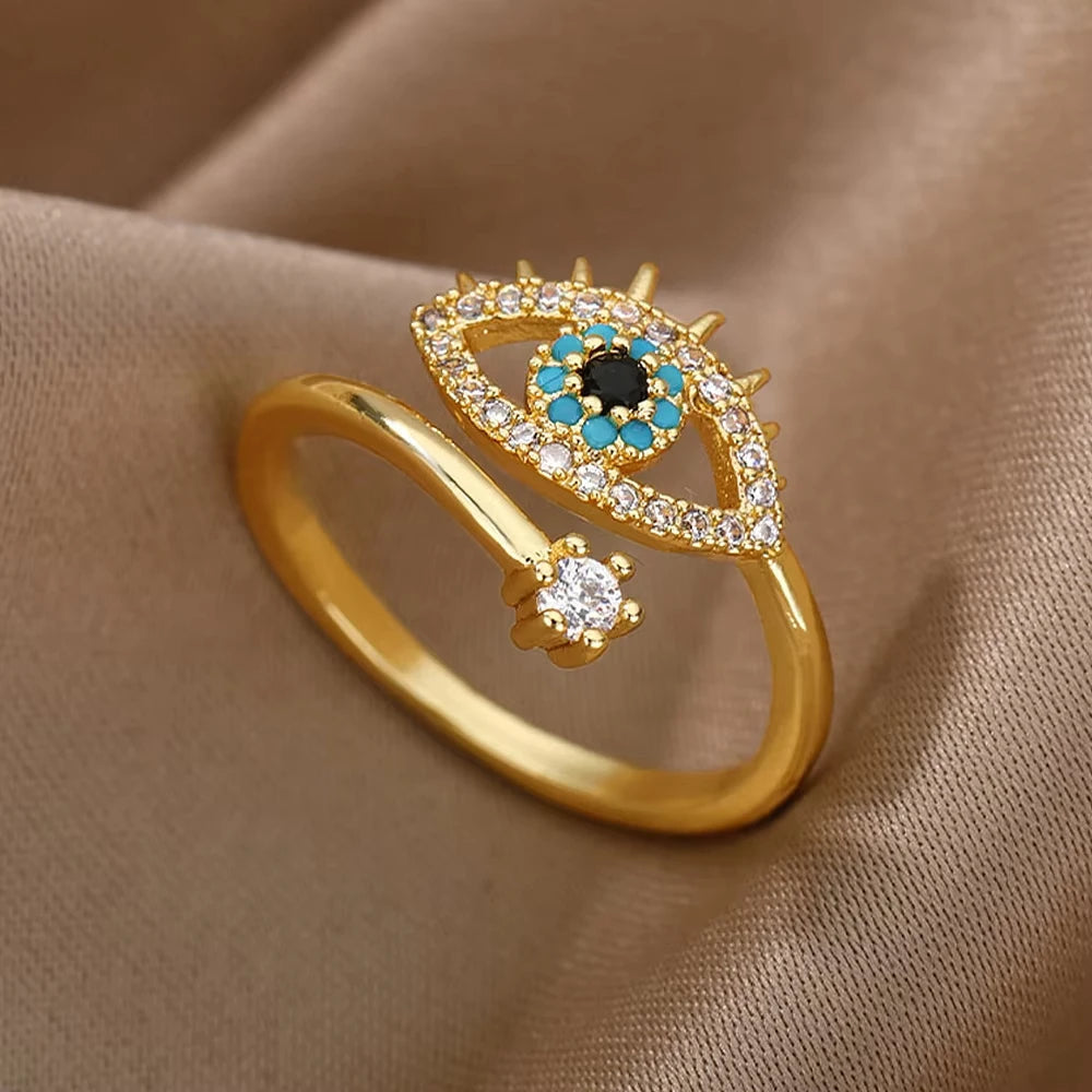 Adjustable blue evil eye ring with turquoise, onyx, and gold-plated stainless steel, designed to protect and attract positivity.