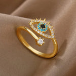 Adjustable blue evil eye ring with turquoise, onyx, and gold-plated stainless steel, designed to protect and attract positivity.