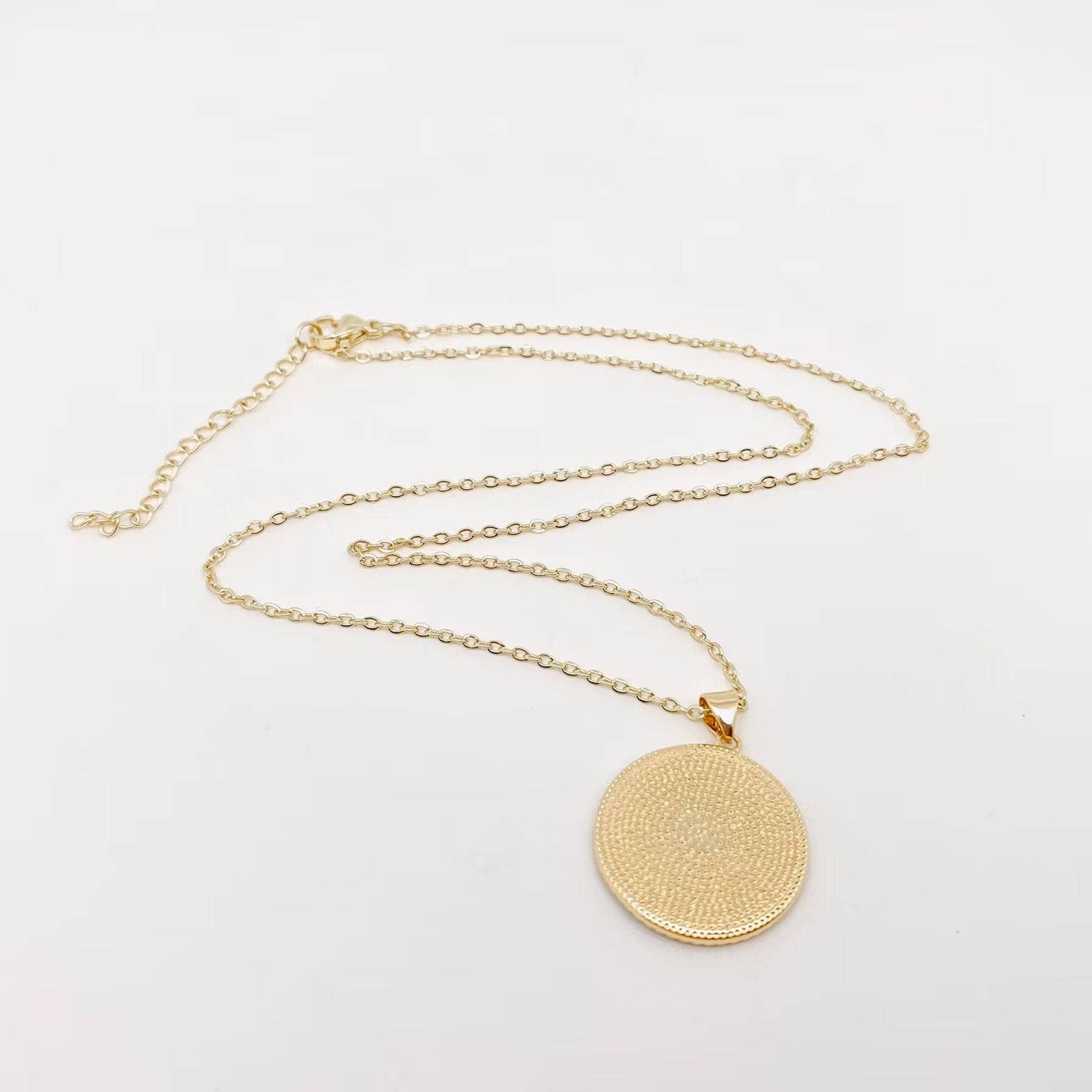Adjustable evil eye necklace with white enamel, blue accents, and gold plated finish, ideal for gifting or layering.