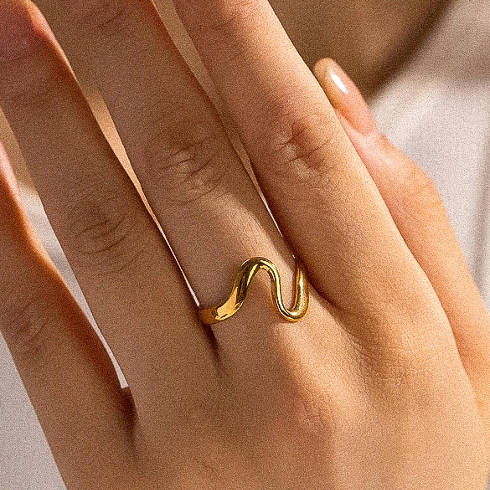 Elegant Adjustable Gold Plated Wave Ring, 18K gold-plated with a smooth, wavy design, perfect for everyday wear and special occasions.