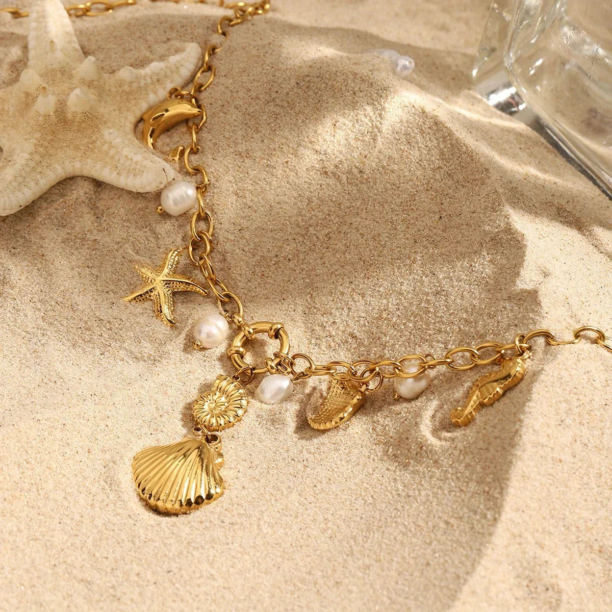 Gold beach charm necklace with seahorse, starfish, and shell pendants, ideal for ocean lovers and everyday wear