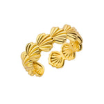 Elegant gold shell ring with adjustable design, blending seaside inspiration with everyday wearability and sparkle