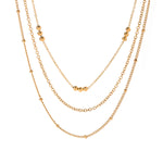 Elegant Beaded Layered Gold Necklace, 18K gold-plated with delicate chains and tiny polished gold beads, perfect for adding style and depth to any outfit.