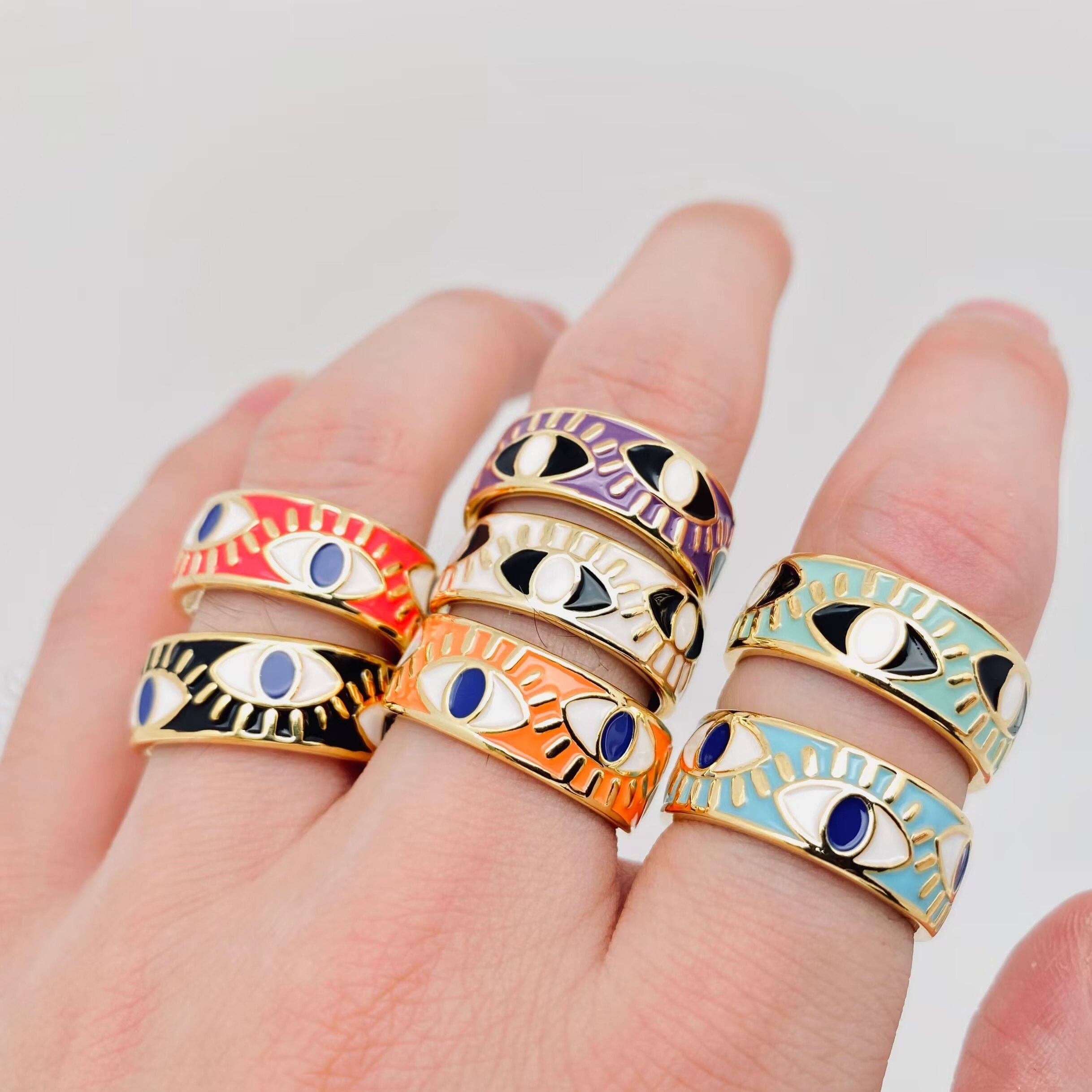Adjustable black enamel evil eye ring with gold-plated stainless steel, featuring deep blue and gold protective design, perfect for daily wear.