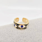 Gold-plated black enamel evil eye ring with deep blue details, offering everyday style and protective symbolism