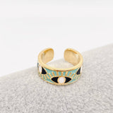 Blue enamel evil eye ring with gold details, designed for women seeking a symbolic and trendy jewelry piece