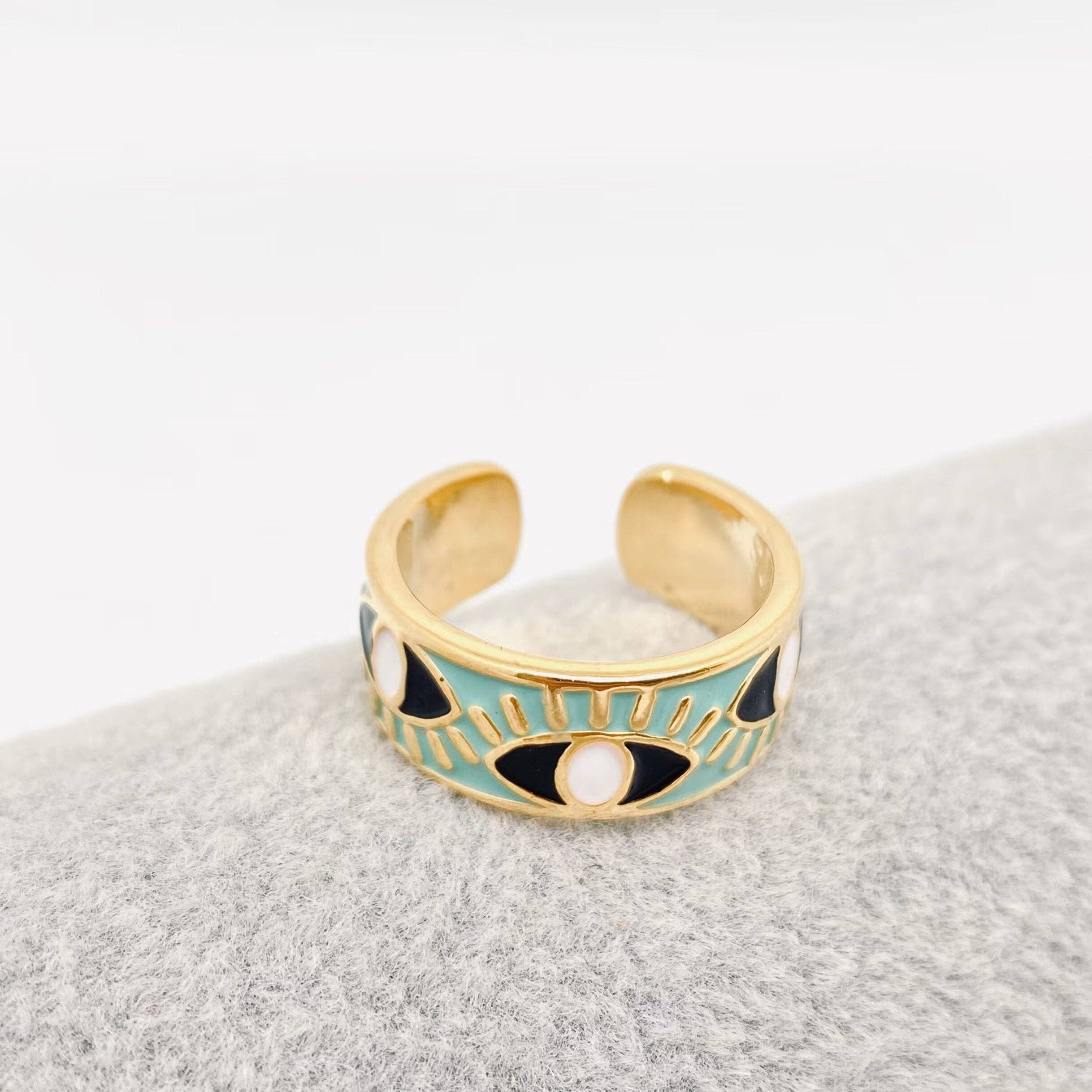 Blue enamel evil eye ring with gold details, designed for women seeking a symbolic and trendy jewelry piece