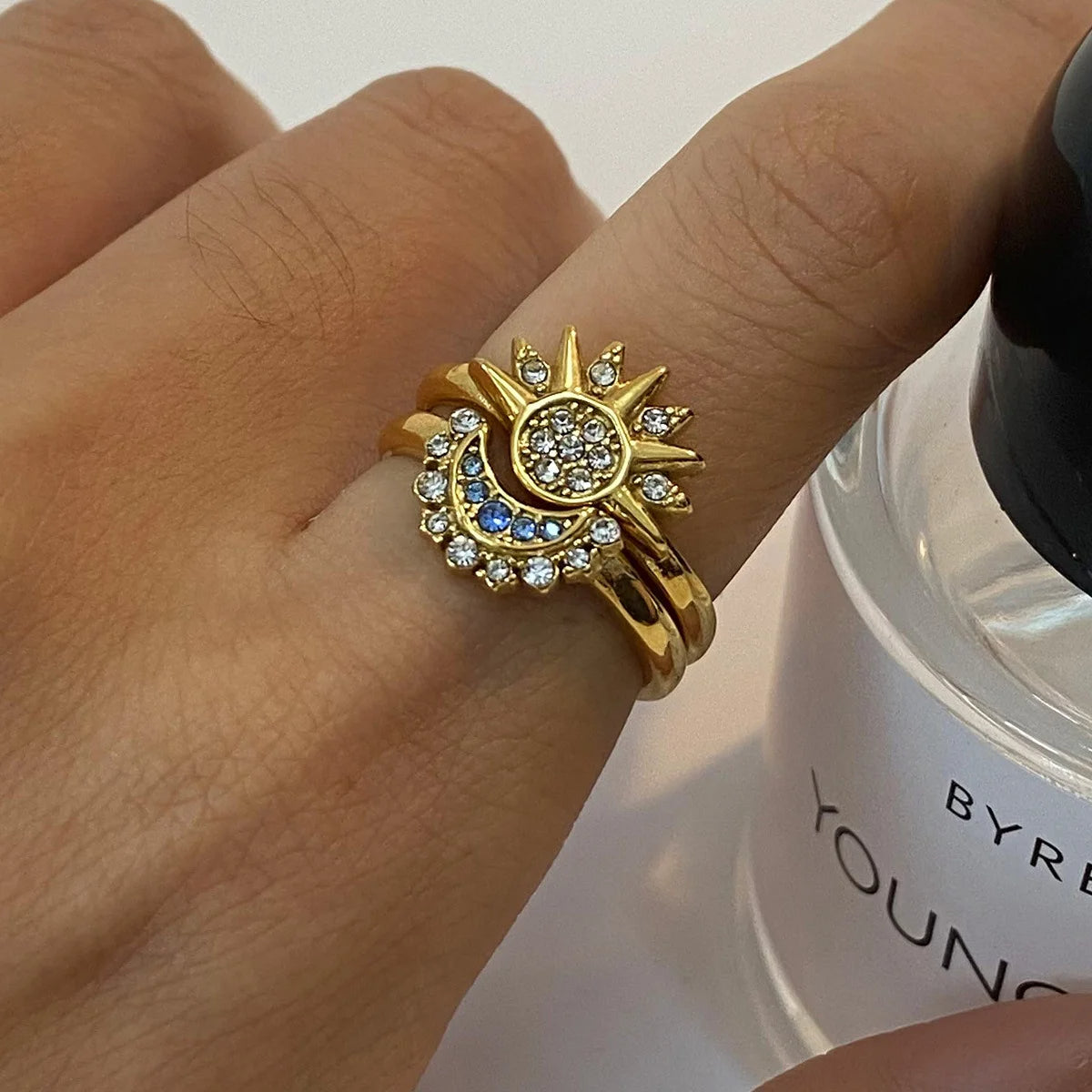 Celestial gold ring featuring sun and moon design with sparkling accents, adjustable and elegant for daily wear.