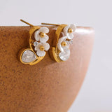 Elegant cherry blossom stud earrings with gold plating and white petals, accented by sparkling cubic zirconia