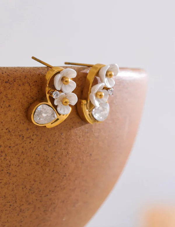 Elegant cherry blossom stud earrings with gold plating and white petals, accented by sparkling cubic zirconia