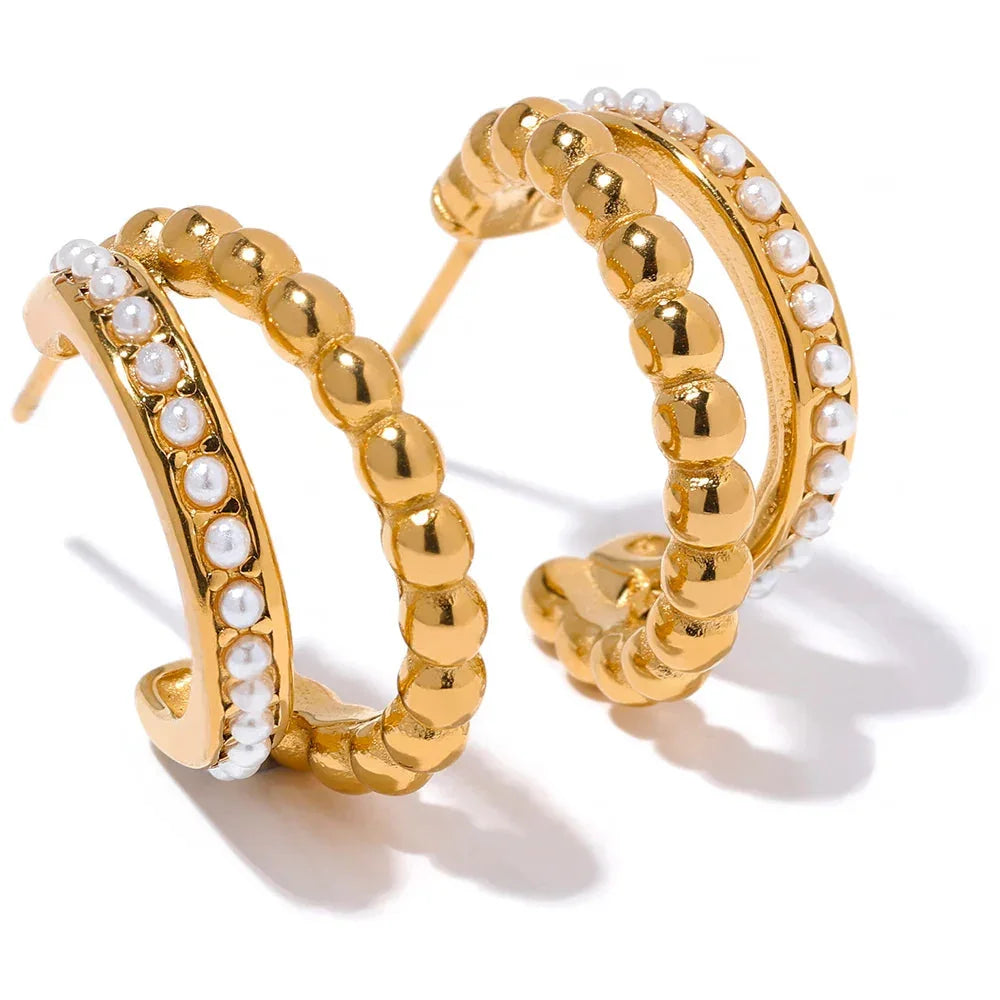 Double stacked pearl hoop earrings with 18k gold plating on stainless steel, offering a modern layered design and classic pearl accents.