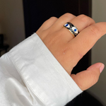 Adjustable black enamel evil eye ring with gold-plated stainless steel and blue eye detail, a stylish protective accessory for everyday wear.