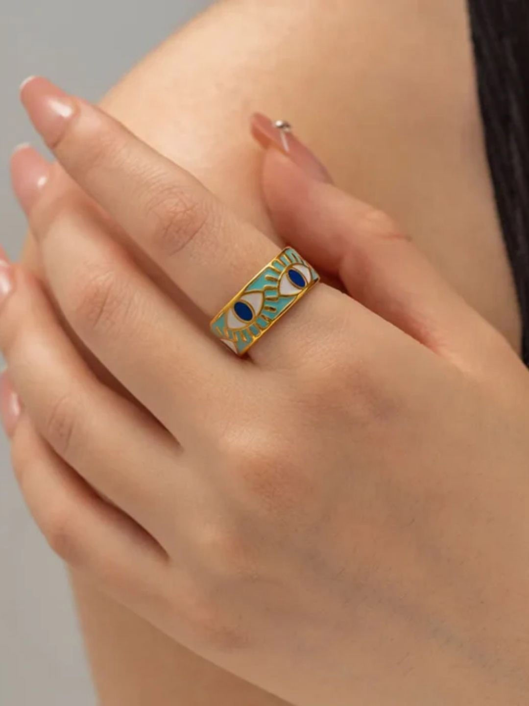 Deep blue enamel evil eye ring with gold stainless steel band, combining modern style with meaningful symbolism