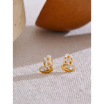 Gold-plated floral stud earrings featuring white cherry blossom petals and crystal accents