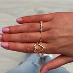 Delicate gold huggie hoop ring with adjustable fit, crafted in 18k gold for a stylish and comfortable everyday accessory