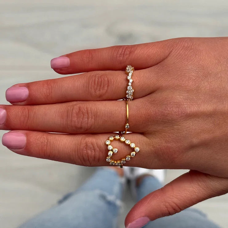 Delicate gold huggie hoop ring with adjustable fit, crafted in 18k gold for a stylish and comfortable everyday accessory