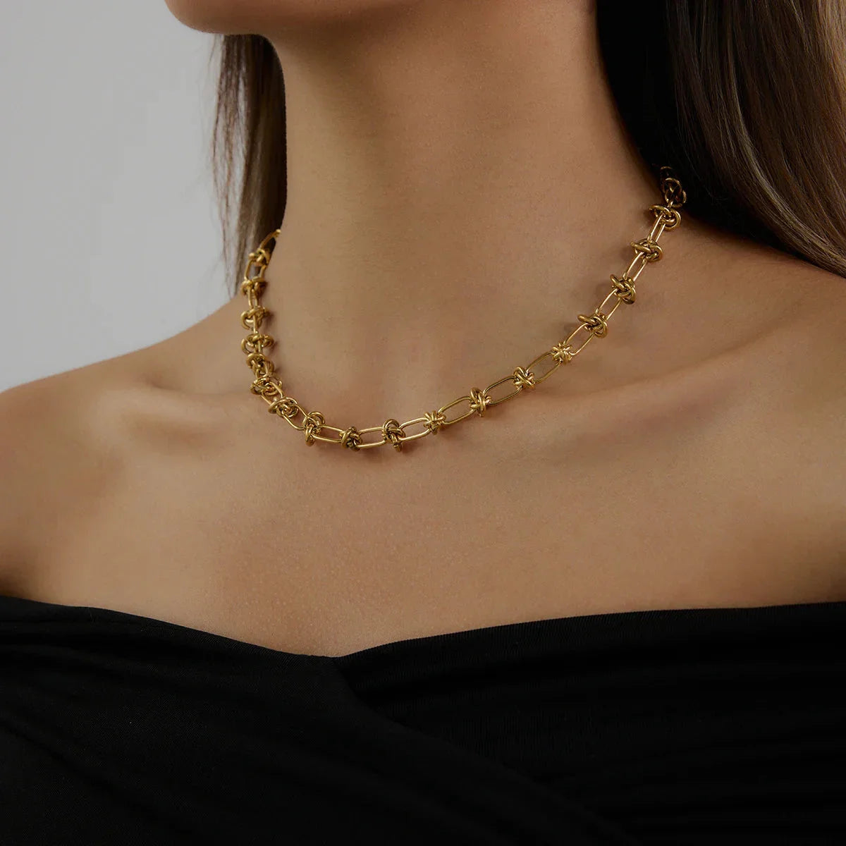 Stylish Luxe Gold Knot Necklace, 18K gold-plated with woven knot design, adding elegance and strength to any outfit for everyday or special occasions.