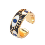 Gold-plated stainless steel evil eye ring with black enamel band and blue and gold eye design, offering protection and stylish elegance.