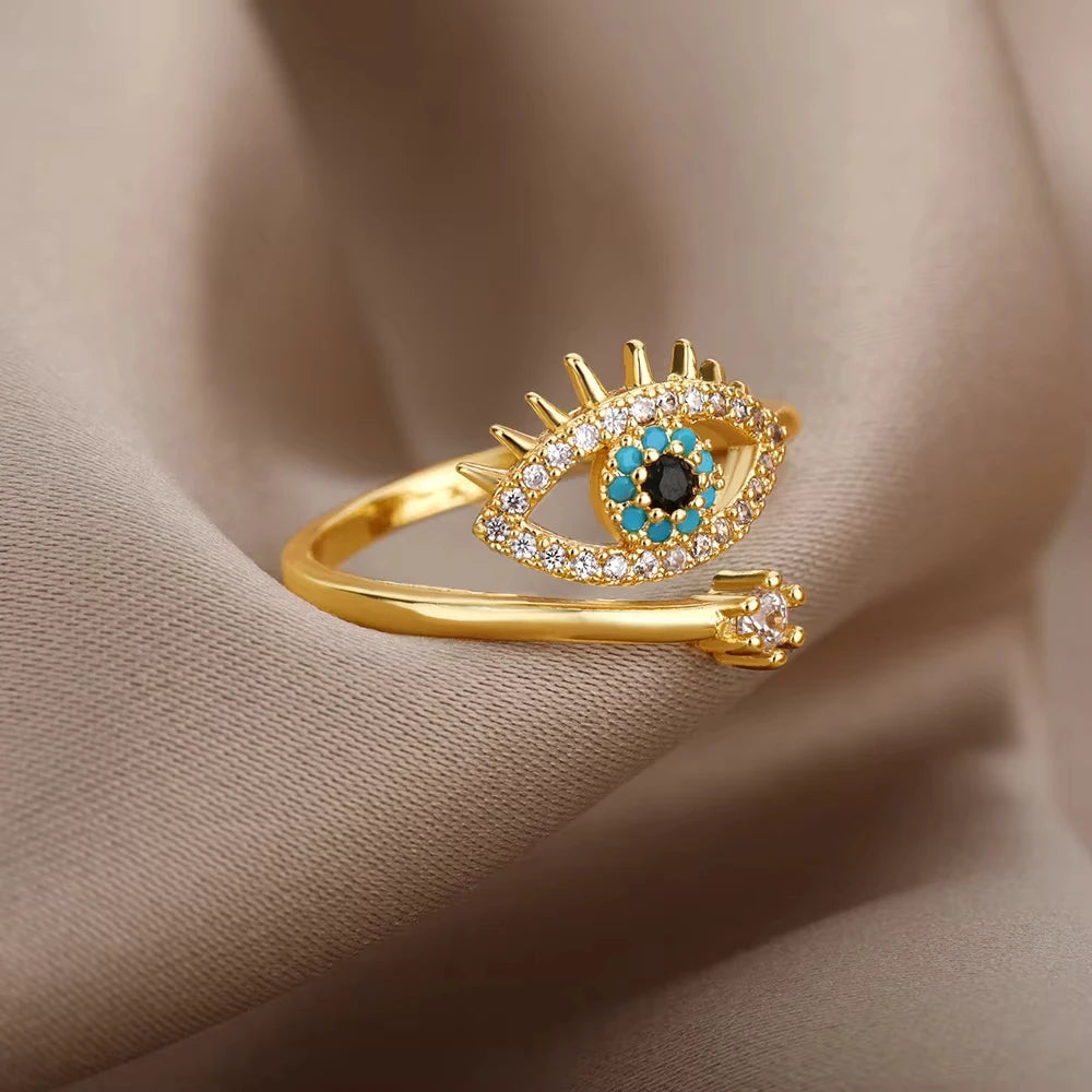 Gold-plated evil eye ring featuring blue stone, symbolic of protection, made with zirconia, turquoise, and onyx for daily wear.