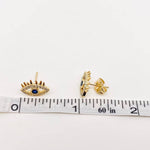 Stylish gold-plated evil eye stud earrings with blue center and cubic zirconia stones, polished lashes design, ideal for layering or solo wear.

