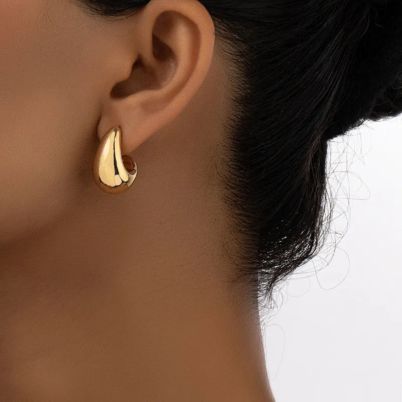 Bold geometric teardrop earrings with 18k gold plating, perfect for adding modern style and shine to any outfit

