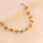 Luxe Gold Woven Knot Necklace, 18K gold-plated, symbolizing strength and connection, perfect for elevating your look with timeless elegance.