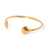Golden two sea shell cuff bracelet with 18K gold plating, lightweight and stylish, perfect for beach-inspired or everyday wear.
