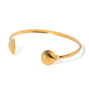 Golden two sea shell cuff bracelet with 18K gold plating, lightweight and stylish, perfect for beach-inspired or everyday wear.
